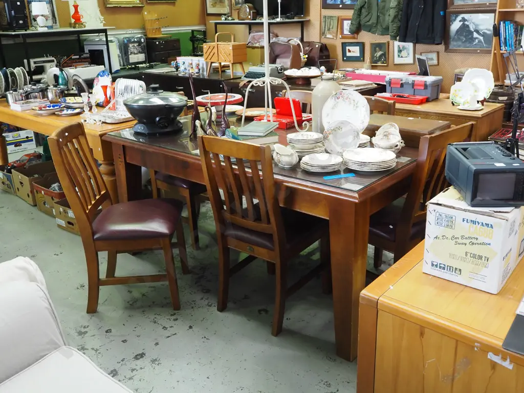 dark stained solid wood table with glass protective pane and matching chairs Image 1++