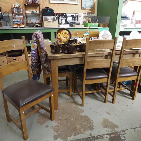 oak extending dining table with 6 matching brown vinyl chairs Closed H790 W1400 D900
