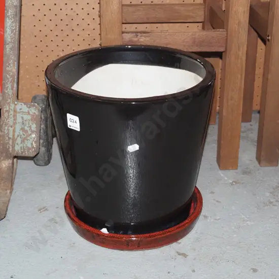 black glazed planter with red  drip tray