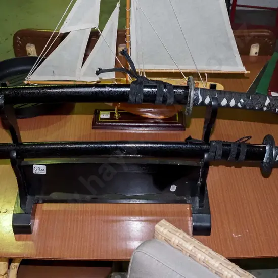 pair of Japanese swords on stand