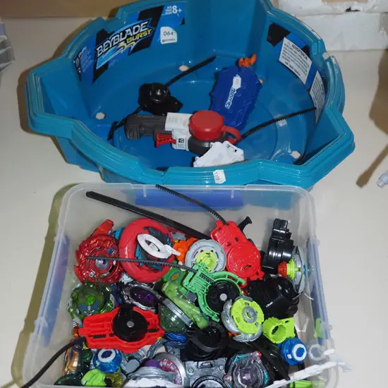 plastic container of Bey Blades and a tournament container