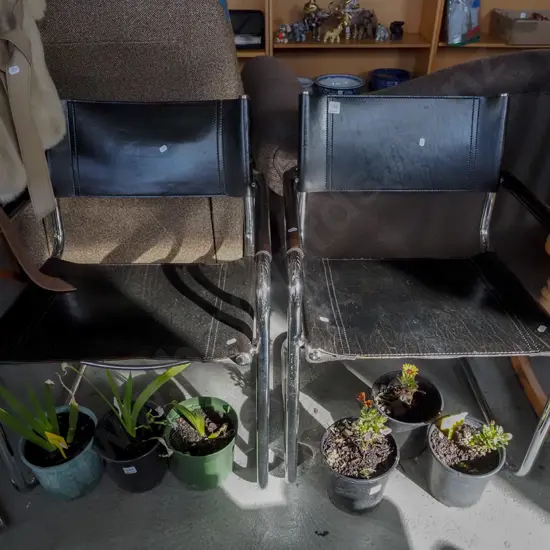 pair of chrome and leather armchairs