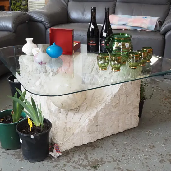 triangular glass top table with unusual composite stone and ball base H410 W960 D690