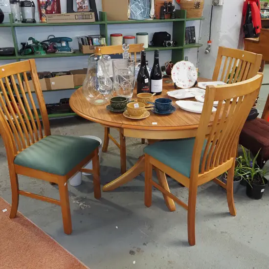 solid rimu and mdf veneer circular pedestal dining table wth 2x extending drop sides and 4 
