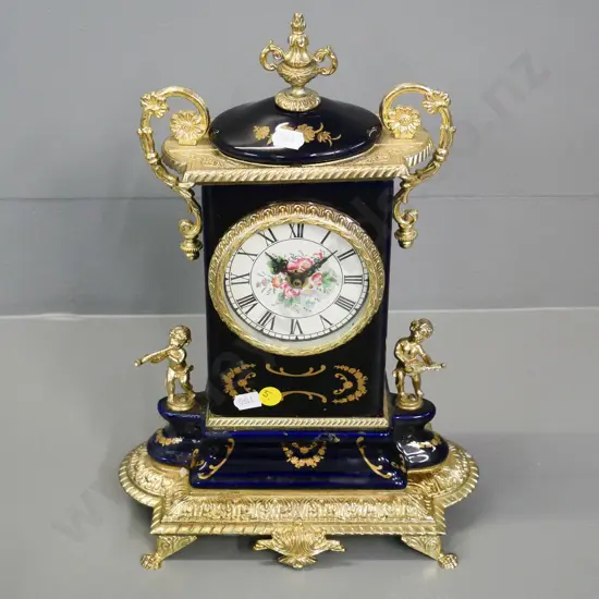 reproduction French style porcelain cased clock with painted dial and brass decoration H-330 W-230