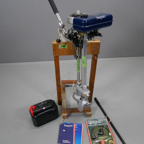 vintage Seagull 40 Plus outboard motor on timber stand with manuals, accessories, tank etc.