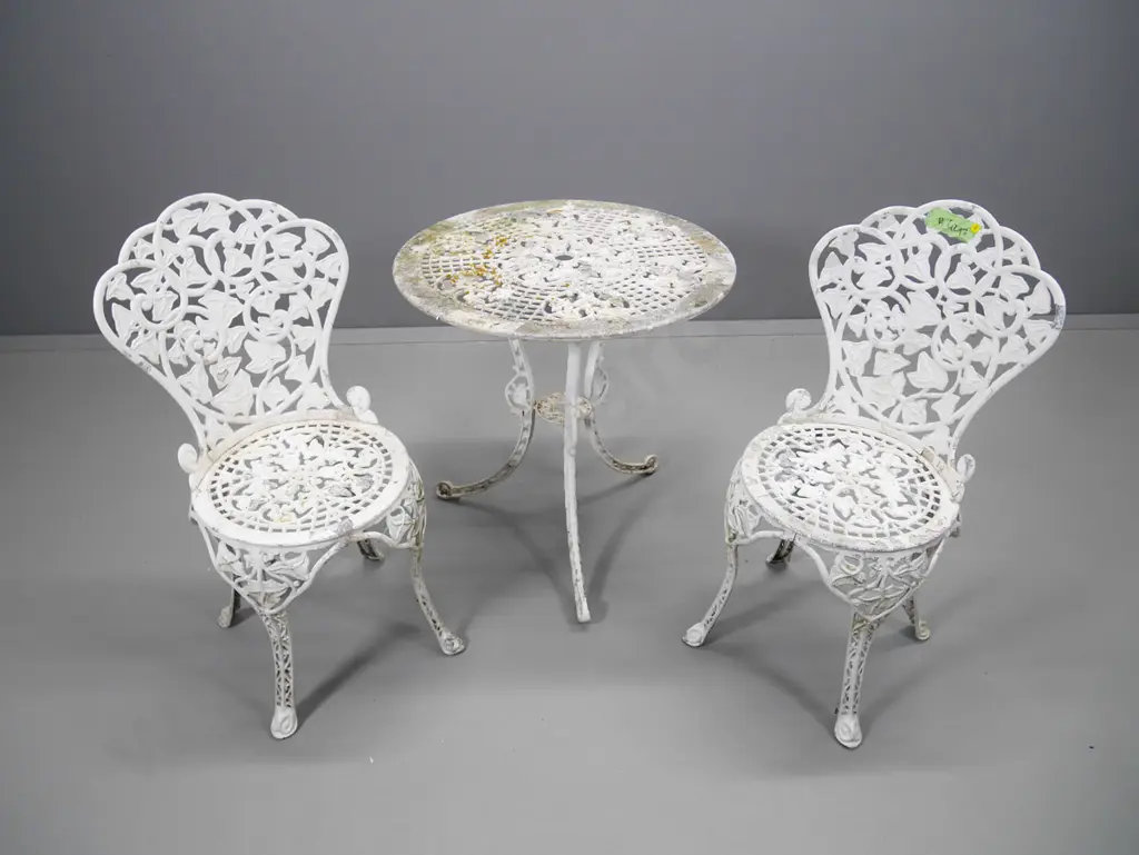 white painted cast aluminium Victorian style outdoor table and 2 chairs - has paint loss. Table H-680 Diameter 660 Image 1++