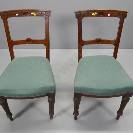 pair of oak carved-back dining chairs with green damask upholstered seats, some looseness in joints