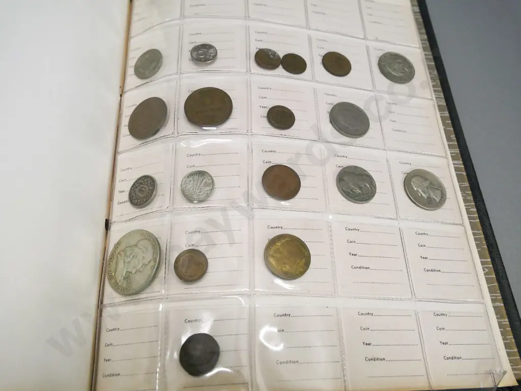 folder of international coins - Ceylon, USA, Australia, bank notes from Laos & German 100,000 mark banknote Image 1++