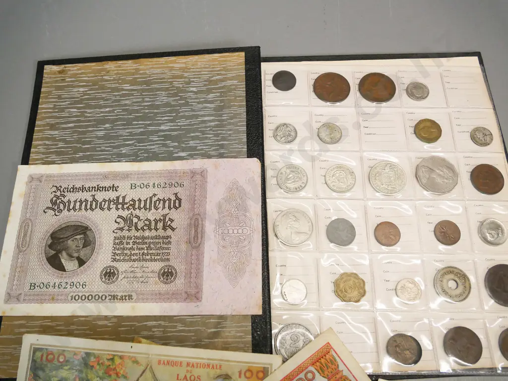 folder of international coins - Ceylon, USA, Australia, bank notes from Laos & German 100,000 mark banknote Image 1++