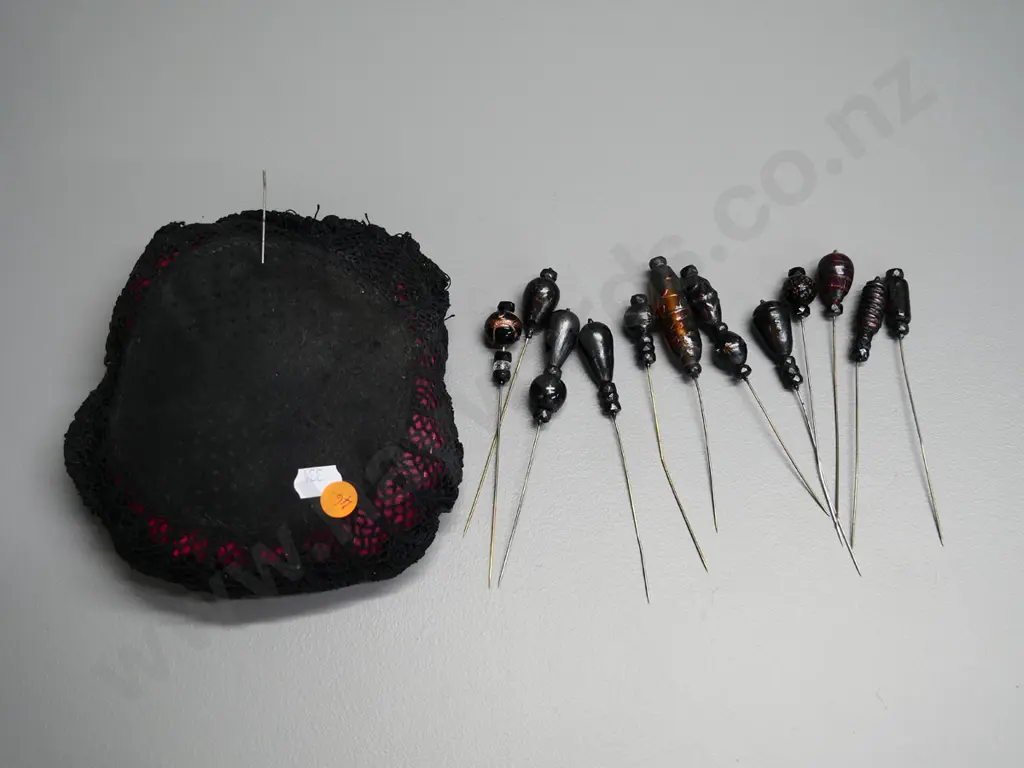 numerous vintage hat pins in fabric covered cushion - some are glass Image 1++
