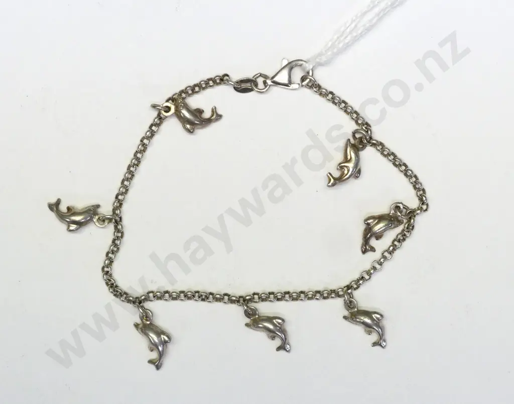 silver charm bracelet with 7 dolphin charms stamped 925 Image 1++