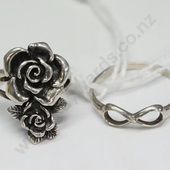 2 silver rings-1 with flowers both stamped 925