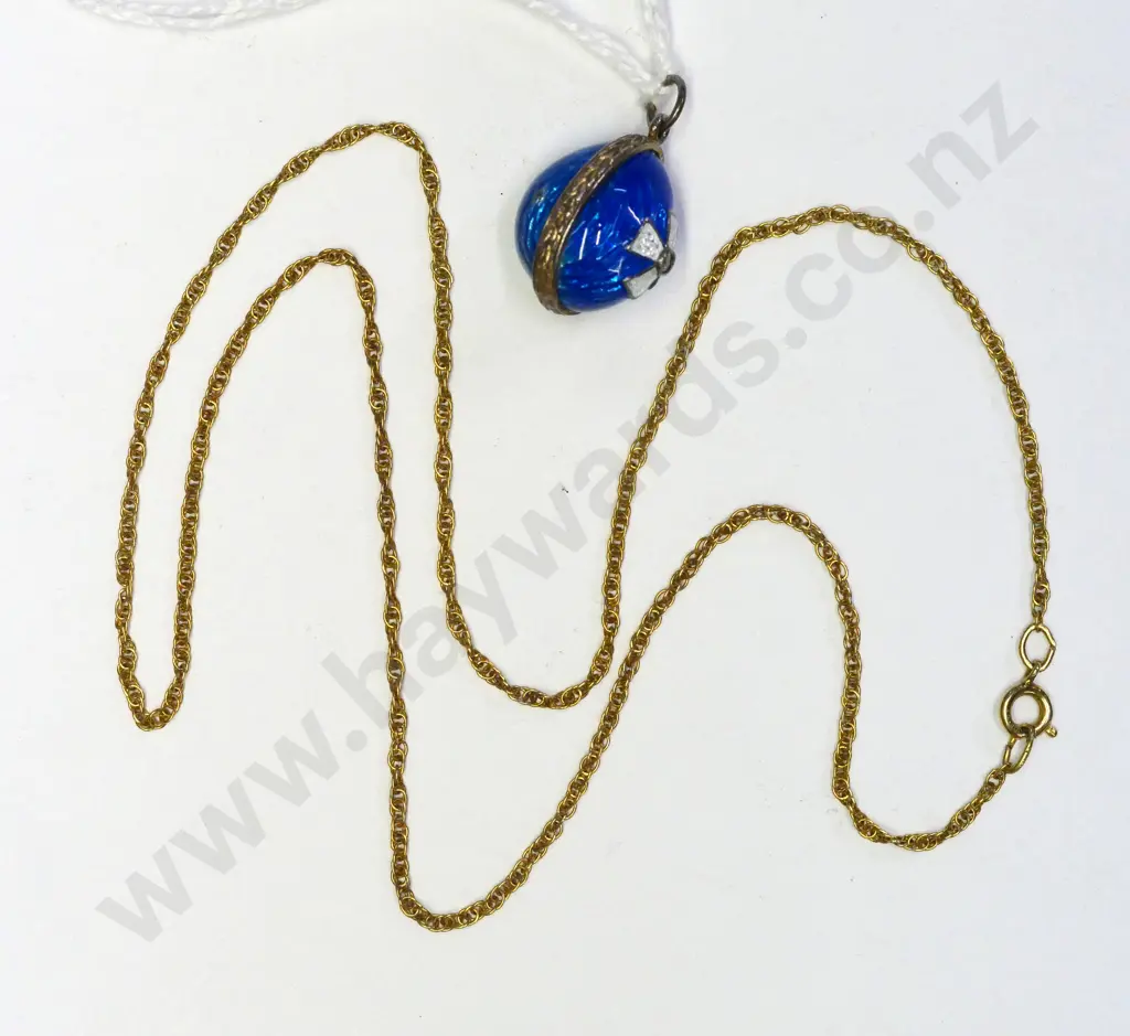 small blue enamel egg and a gold chain no markings Image 1++
