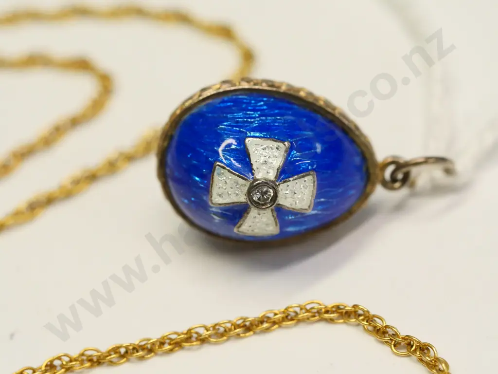 small blue enamel egg and a gold chain no markings Image 1++