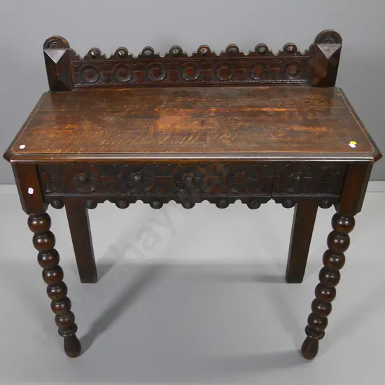 oak heavily carved Tudor style hall table with cotton-reel front legs, polish needs some work H-940 W-880 D-430