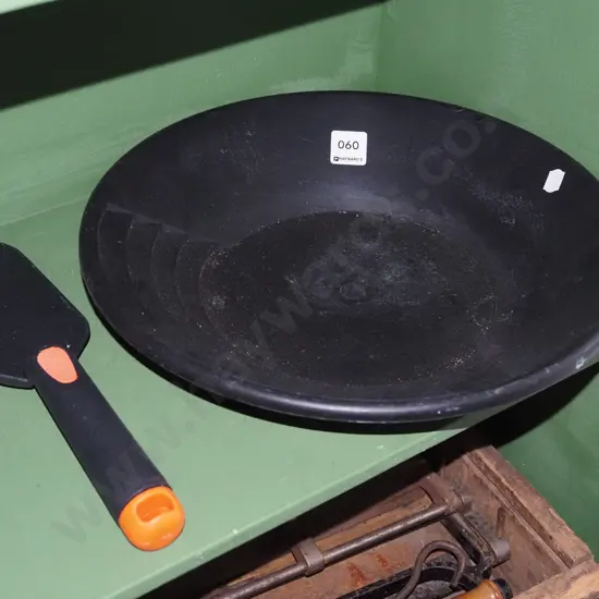 black plastic goldminer's pan and trowel