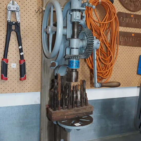 wall mounted hand cranked drill press with various bits