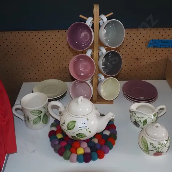 tea cups on stand, saucers, creamer etc