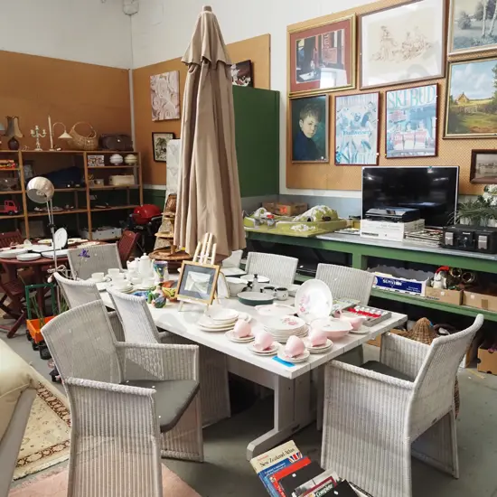 large solid wood white painted outdoor dining table with taupe sun umbrella