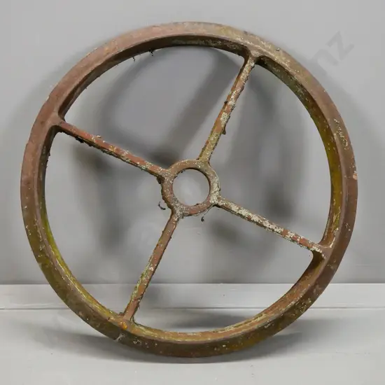 vintage heavy cast iron 4-spoked vehicle or agricultural wheel - age wear & corrosion. Diameter 590.