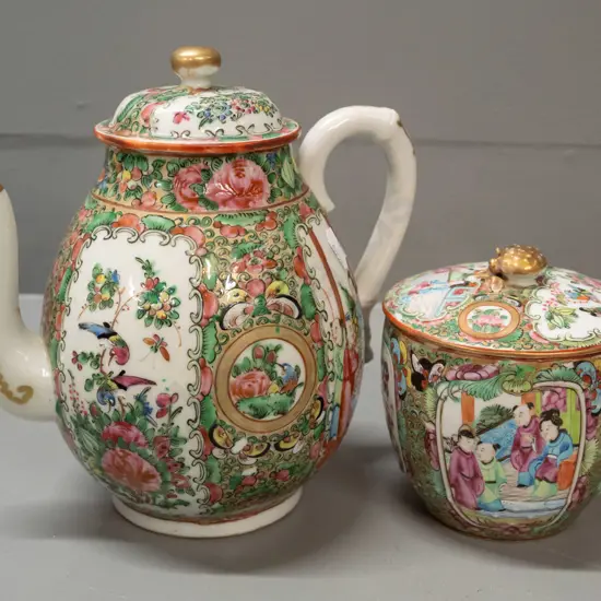 2 pieces of Cantonese china with raised enamel decoration - teapot and a lidded canister. Teapot has repaired chip to