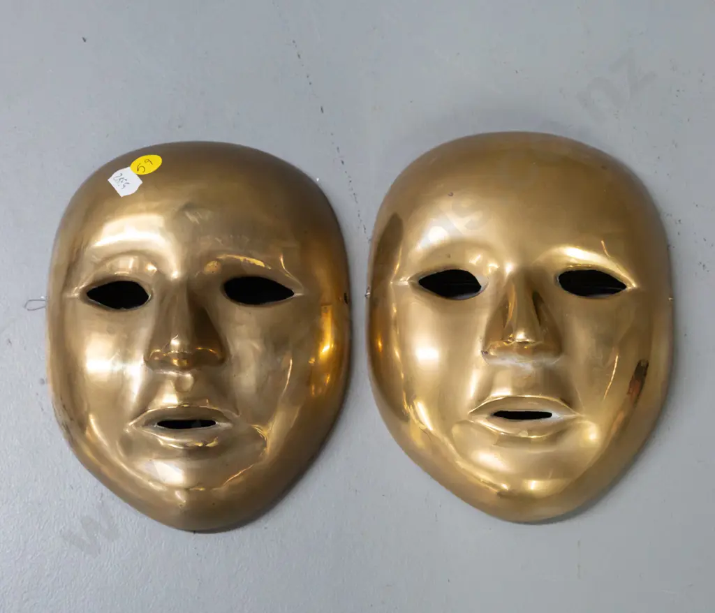 pair of cast brass ornamental wall masks. Hanging wire on one mask is broken. H-170 W-135 Image 1++