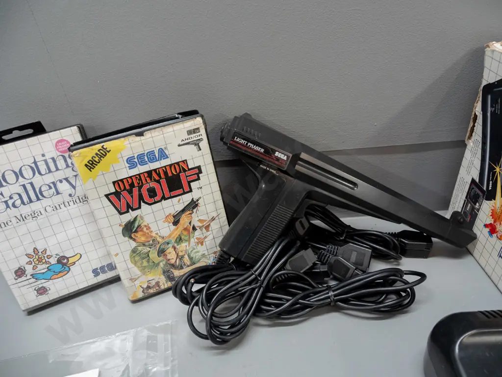 large Sega Master System II collection with 2 consoles, 2 handheld controllers, arcade pistol, numerous game cartridges Image 1++