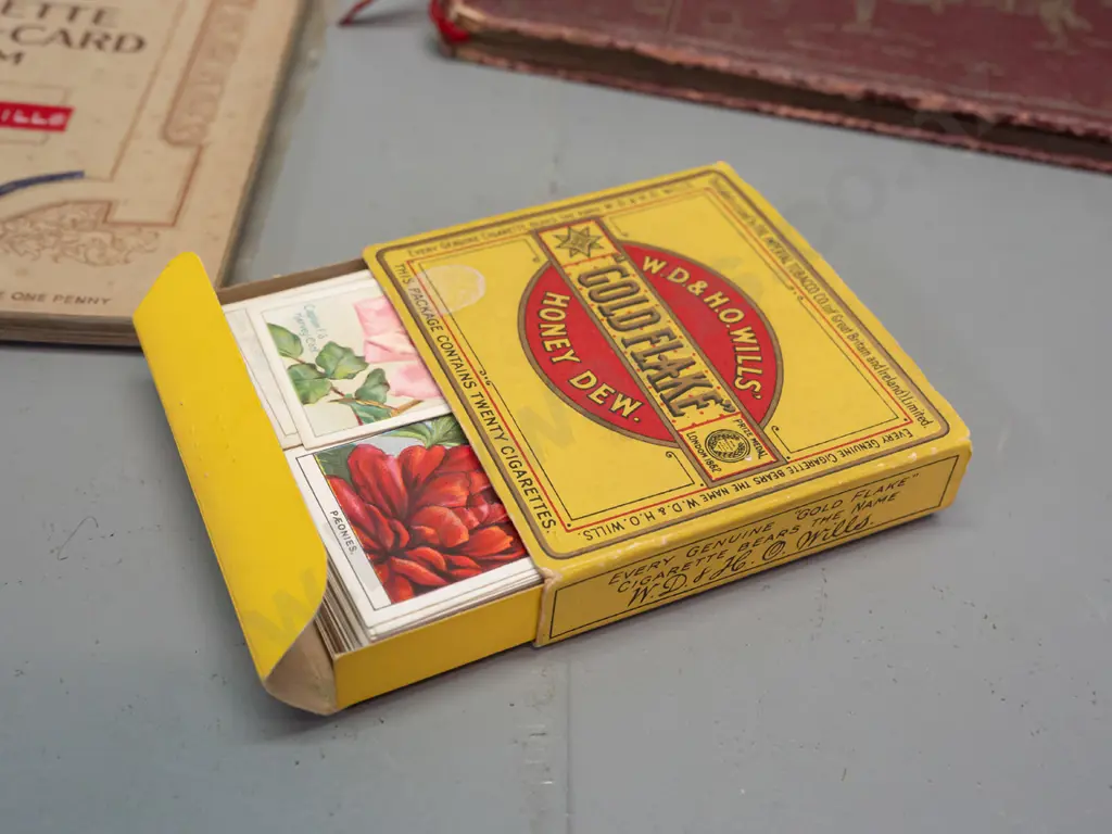 Assorted cigarette collector cards in sheets and albums, including a Wills cigarette box. Albums have partial contents Image 1++
