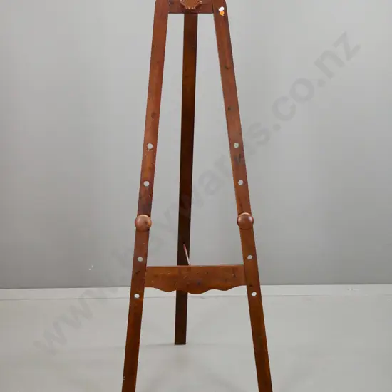 reproduction easel with antiqued surface, turned knob supports, shell motif at top. Loose joints & hinge could use some