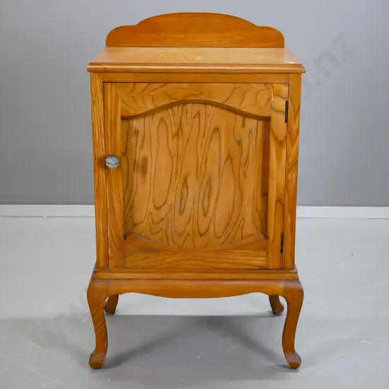 vintage oak and elm cab leg bedside cabinet w/ panelled door, bakelite handle. A few dents to top edge, borer in back &
