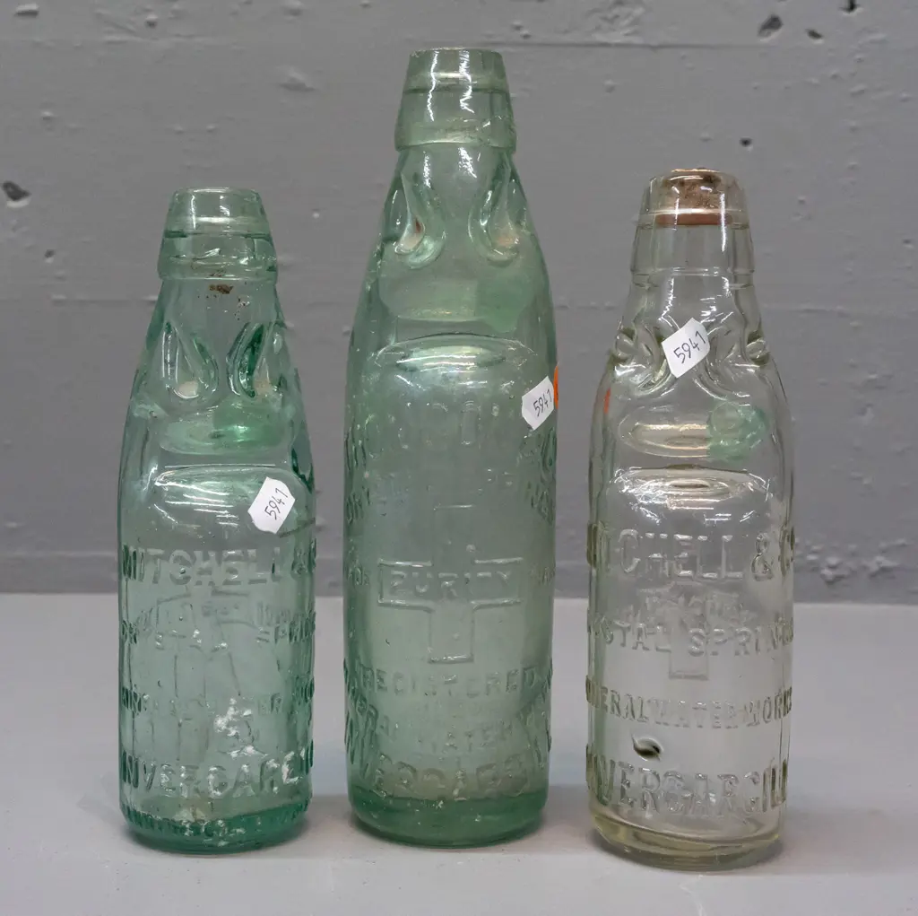 3 clear glass codd / marble bottles - 2 are Mitchell & Co Invercargill, one marked MGB Co. on back, no date, other 1899 Image 1++