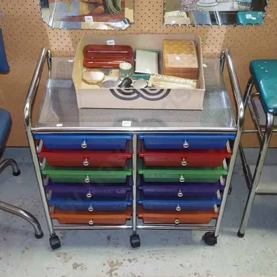multi coloured plastic organiser trays in metal frame on casters