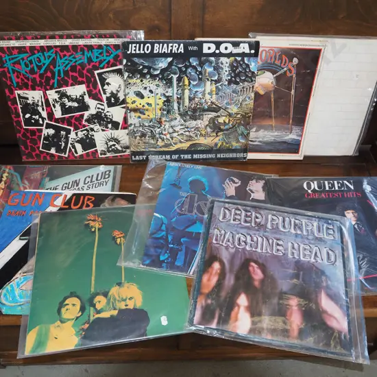 stack of LPs; Pink Floyd, War of the Worlds, Queen etc