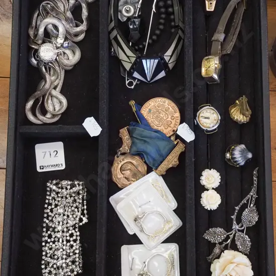 segmented black velvet tray; necklaces, medals, marcasite brooch etc