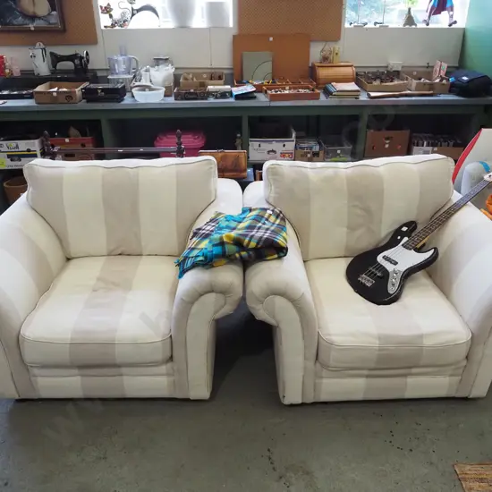 pair of large tapue and cream upholstered armchairs
