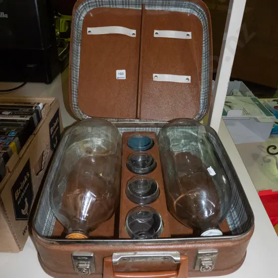 2x flagons and 4 glasses in suitcase