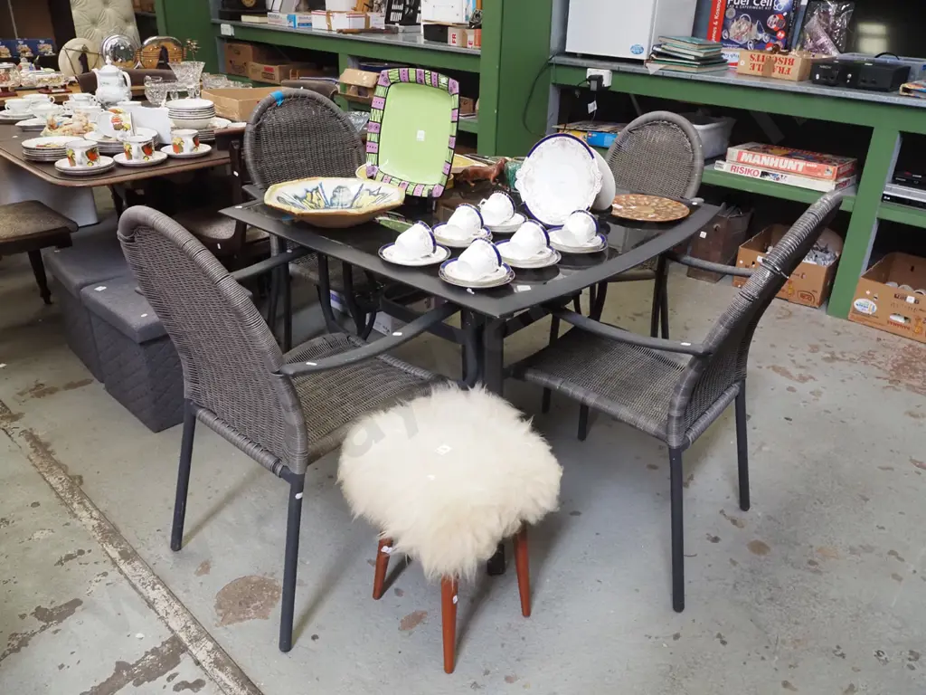 alloy and black glass top outdoor table with 4 matching woven plastic armchairs H740 W930 D1020 Image 1++