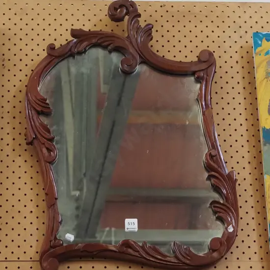 ornately carved framed wall mirror