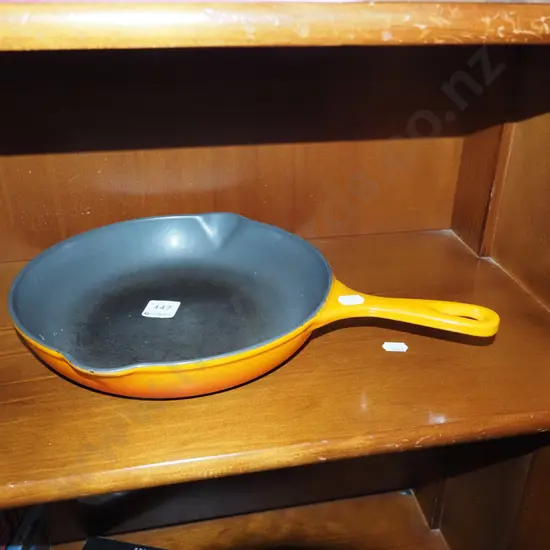 orange enamel and cast iron Le Creuset frying pan