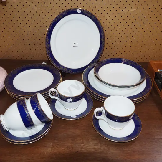 assorted blue, gold and white Noritake plates, bowls, cups
