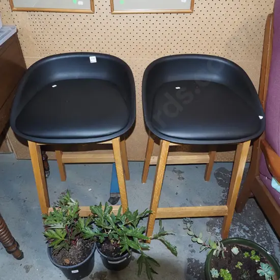 pair of vinyl, plastic and wood bar stools
