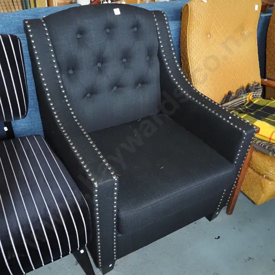 contemporary black upholstered deep buttoned armchair with chrome dome edging