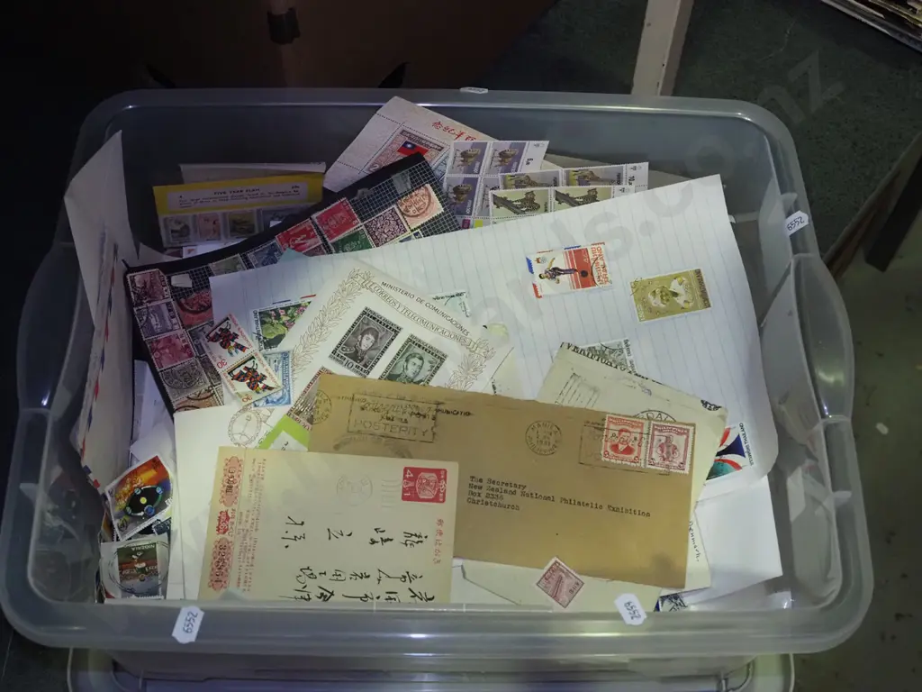 lidded plastic tub of stamps Image 1++