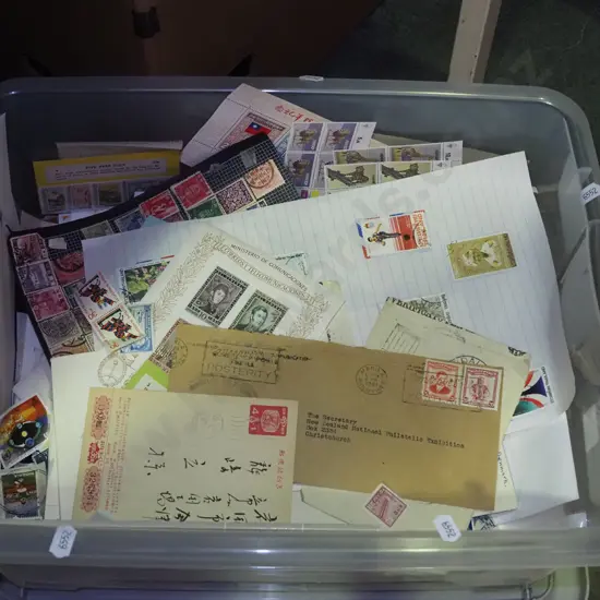 lidded plastic tub of stamps