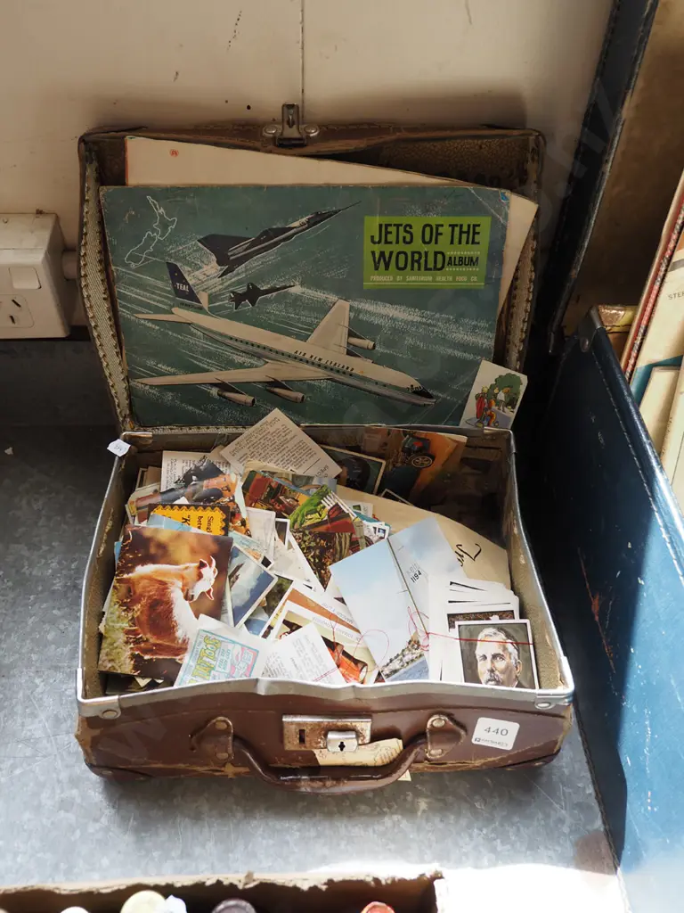 small battered suitcase with collector cards and albums Image 1++