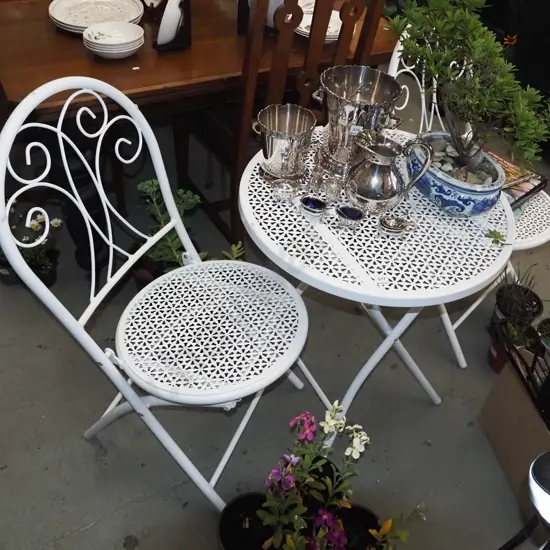 white metal foldout patio table with 2 chairs