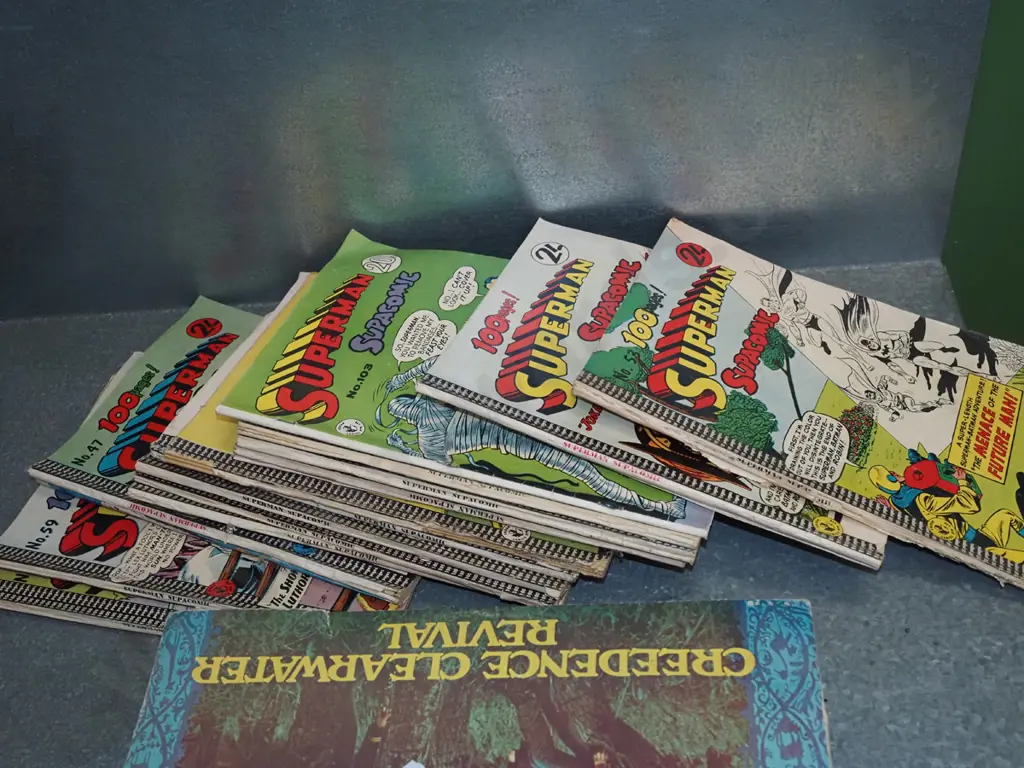 stack of Superman comics Image 1++