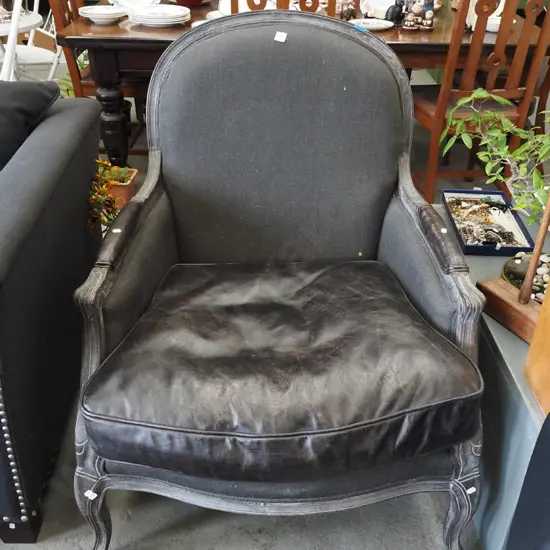 leather and charcoal upholstered carved wooden armchair