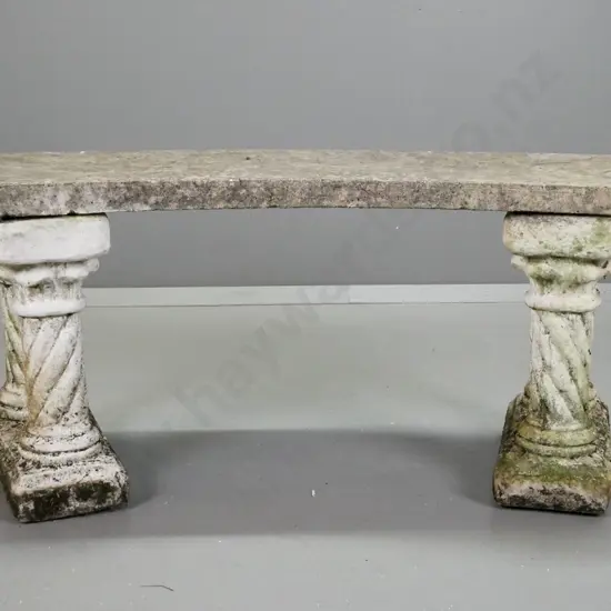 concrete crescent shaped garden seat on painted double spiral column end supports with age and moss patina. Minor